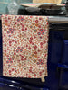 Floral-patterned towel hanging on a stove handle
