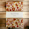 Red Folk Floral Print Organic Cotton Apron folded in Edge of the meadow Branding 